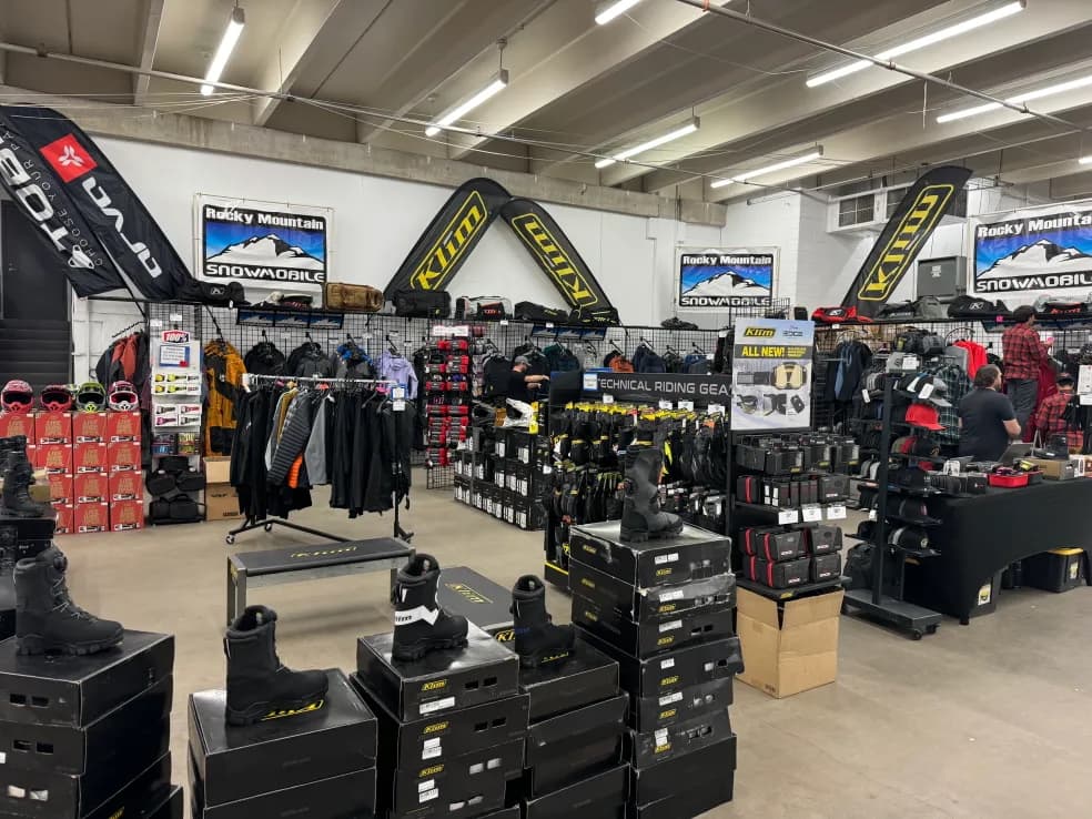 Vendor booth with winter powersports gear displays at the Colorado Snomo Expo