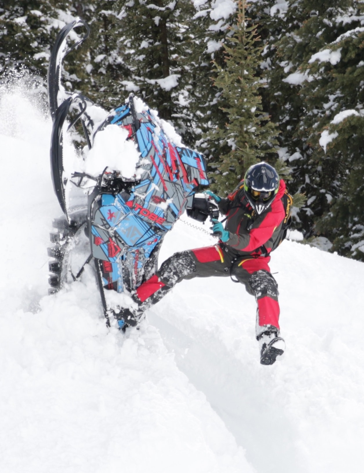 Snowmobiler carving through deep powder in a snowy Colorado forest
